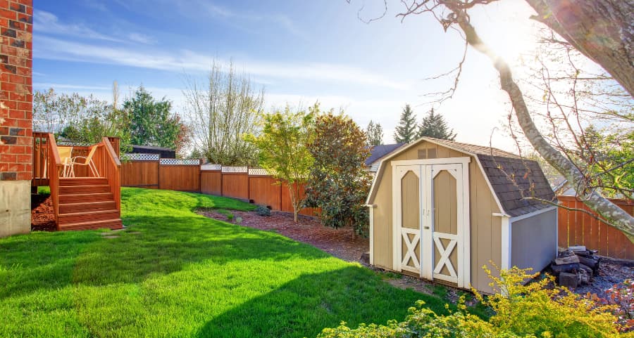 Fenced backyard with storage shed in New York City